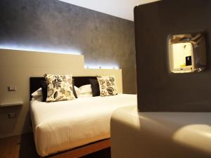 a bedroom with a white bed with a mirror at Verona Center in Verona