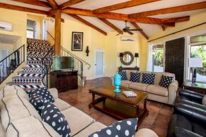 a living room with a couch and a table at Luxury Flamingo home with ocean view sleeps 10 - walking distance from beach in Playa Flamingo