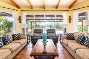 a living room with couches and a table at Luxury Flamingo home with ocean view sleeps 10 - walking distance from beach in Playa Flamingo +40 photos