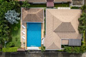 an overhead view of a house with a swimming pool at Villa with Huge Private Pool and Tropical Garden Just 10 Minutes Walk to Kamala Beach in Kamala Beach