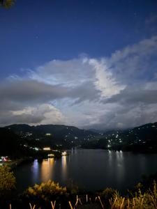 a view of a large body of water at night at Begnas horizon in Pokhara