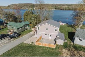an aerial view of a house next to a lake at Riverview Cottage Escape in Frankford
