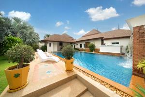 an image of a swimming pool in a house at Villa with Huge Private Pool and Tropical Garden Just 10 Minutes Walk to Kamala Beach in Kamala Beach