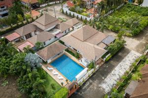 an aerial view of a house with a swimming pool at Villa with Huge Private Pool and Tropical Garden Just 10 Minutes Walk to Kamala Beach in Kamala Beach
