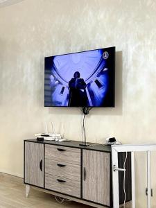 a flat screen tv hanging on a wall at Yoff Oasis Duplex in Dakar