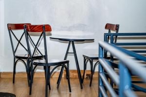 three chairs and a table in a room at Urban Haven in Kigali