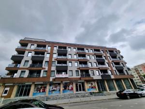a tall building with advertisements on the side of it at Flex loft in Sofia
