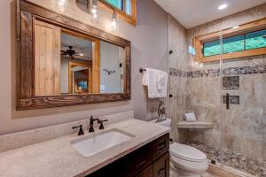 a bathroom with a sink and a toilet and a mirror at Banner View in Banner Elk +31 photos