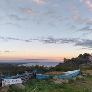 two boats sitting on the side of a hill at Karma Rural Buenavista in Santa Marinella