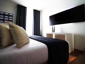 a hotel room with a bed and a flat screen tv at Verona Center in Verona