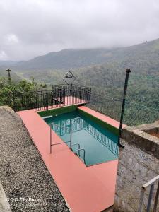 a swimming pool on the side of a mountain at Thazhvaram Pool Resort CalvaryMount in Idukki