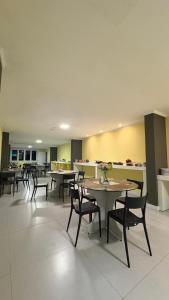 a cafeteria with tables and chairs and a counter at ÓPER SMART HOTEL in Santa Maria