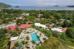 an aerial view of a resort with a swimming pool at Tropical Condo with Spectacular Ocean Views, Panoramic Dining Terrace & Quick Walk to Beach in Coco