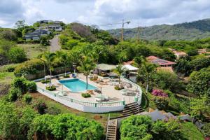 an aerial view of a house with a swimming pool at Tropical Condo with Spectacular Ocean Views, Panoramic Dining Terrace & Quick Walk to Beach in Coco