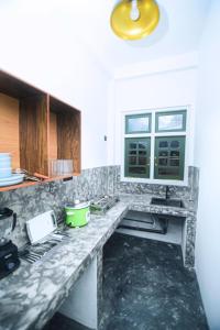 a kitchen with a marble counter top with a sink at Villa Vows in Tangalle +18 photos