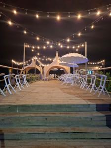 Un paseo marítimo con sillas blancas y sombrillas por la noche. en Hotel La Fragata, en Coveñas 43 fotos más