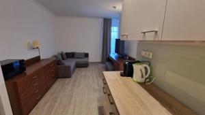 a living room with a couch and a tv at Drazdiak House Antolska Lake View in Bratislava