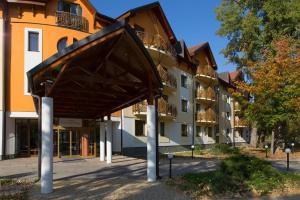 a building with a sculpture in front of it at Drazdiak House Antolska Lake View in Bratislava