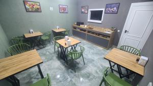a restaurant with tables and chairs and a counter at Imran Hotel Navoiy in Navoi