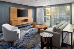 a living room with a couch and a tv at Fairfield Inn & Suites by Marriott Frederick in Frederick