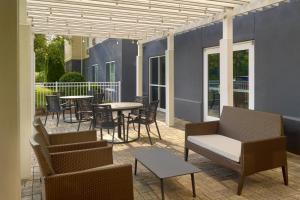 a patio with tables and chairs and a table and chairs at Fairfield Inn & Suites by Marriott Frederick in Frederick