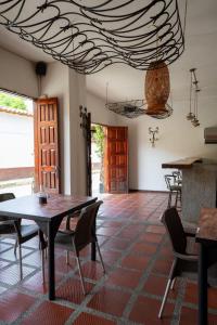 a dining room with a table and chairs and a ceiling at Curazao Hotel -Centro Histórico- in Santa Fe de Antioquia +69 photos
