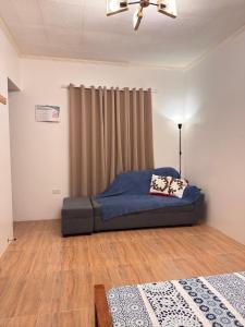a bedroom with a blue bed in a room at Casa Tres16 - Your Private Cozy Retreat in Pilar +21 photos