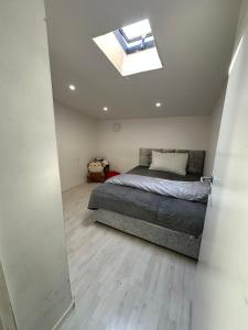 a bedroom with a bed and a skylight at Stort luksus Villa in Søborg