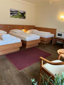 Una habitación de hotel con tres camas y un televisor. en Hotel Falk, en Bremen