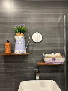 a bathroom with a sink and a toilet and a mirror at The Tartan Sheep in Kilmarnock