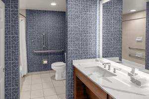 a bathroom with a white sink and a toilet at Homewood Suites by Hilton New Orleans in New Orleans