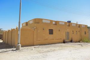 a large brown brick building in the desert at شاليه سيوة - Chalet Siwa in Siwa