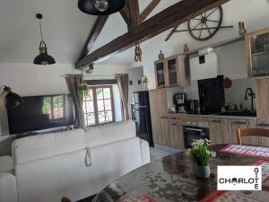 a living room with a couch and a table at Gîte Charlot - Proche Futuroscope Aquascope in Migné-Auxances