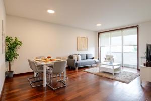 a living room with a table and a couch at Modern & Spacious Flat with Garage by HostWise in Vila Nova de Gaia