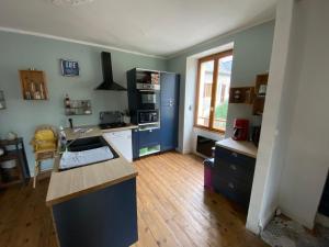 a kitchen with blue cabinets and a counter top at La maison à la porte bleue in Voutezac