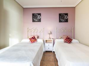 2 letti in una camera con pareti rosa di Ap mayorazgo ii a Salobreña Altre 36 foto