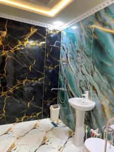 a bathroom with a toilet and a sink in a room at Хостел Истиклол in Fergana