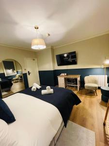 a bedroom with a large bed with two towels on it at Eurobar & Hotel in Oxford +33 photos