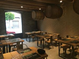 a room with wooden tables and chairs and a window at Hostal 1888 in Gironella