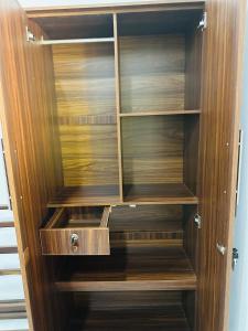 a wooden cabinet with wooden shelves in a room at Villa Cinnaro in Ahangama