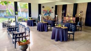 a group of tables and chairs with purple table cloths at The Colony Hotel in Habaraduwa +32 photos