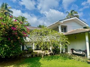 a house with a garden and flowers at The Colony Hotel in Habaraduwa
