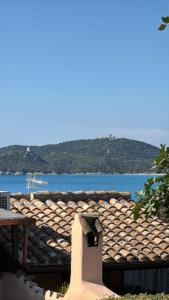 a roof of a house with a view of the ocean at Dimora Su Tramonti a due passi dal mare! in Is Traias