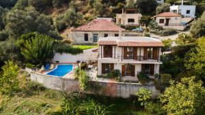 a house with a boat in the water at Villa Eleni Meskla in Mesklá