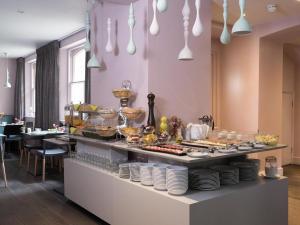 a buffet with a lot of food on a table at The Chapter Hotels -Lancaster Gate in London