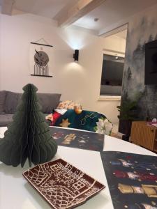 a living room with a christmas tree on a table at Domek Marzenie in Radawa