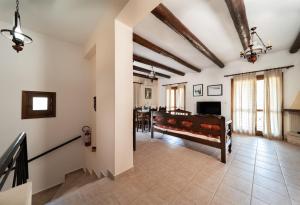 a living room with white walls and wooden beams at Villa Eleni Meskla in Mesklá