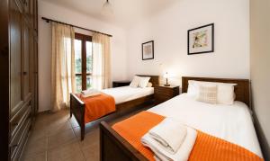 a bedroom with two beds and a window at Villa Eleni Meskla in Mesklá +43 photos