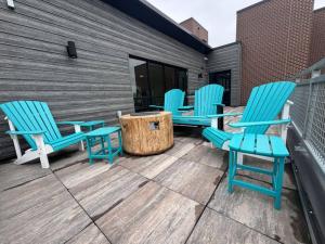 a group of blue chairs sitting on a deck at Evergreen Nook in Des Moines