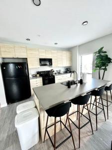 a kitchen with a table and some chairs in it at Monochrome Den in Des Moines